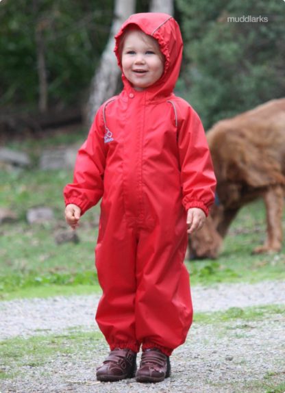 girl wearing muddlarks® all-in-one one piece waterproof suit with hood on