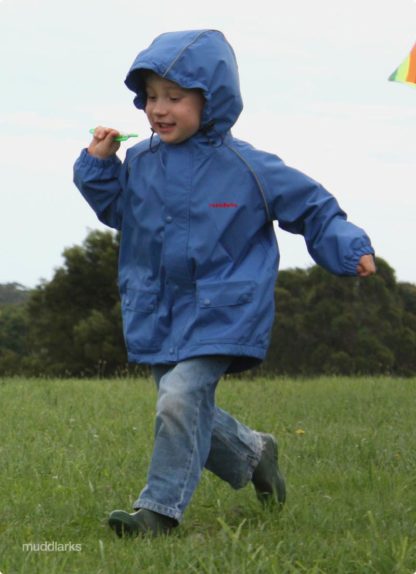 By flying kite wearing blue muddlarks® lark jacket with hood on